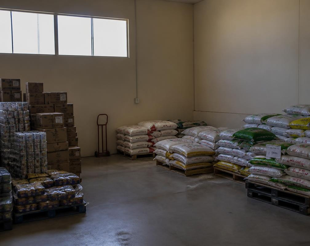 Dimly monitored storage area with stacked goods and pallets